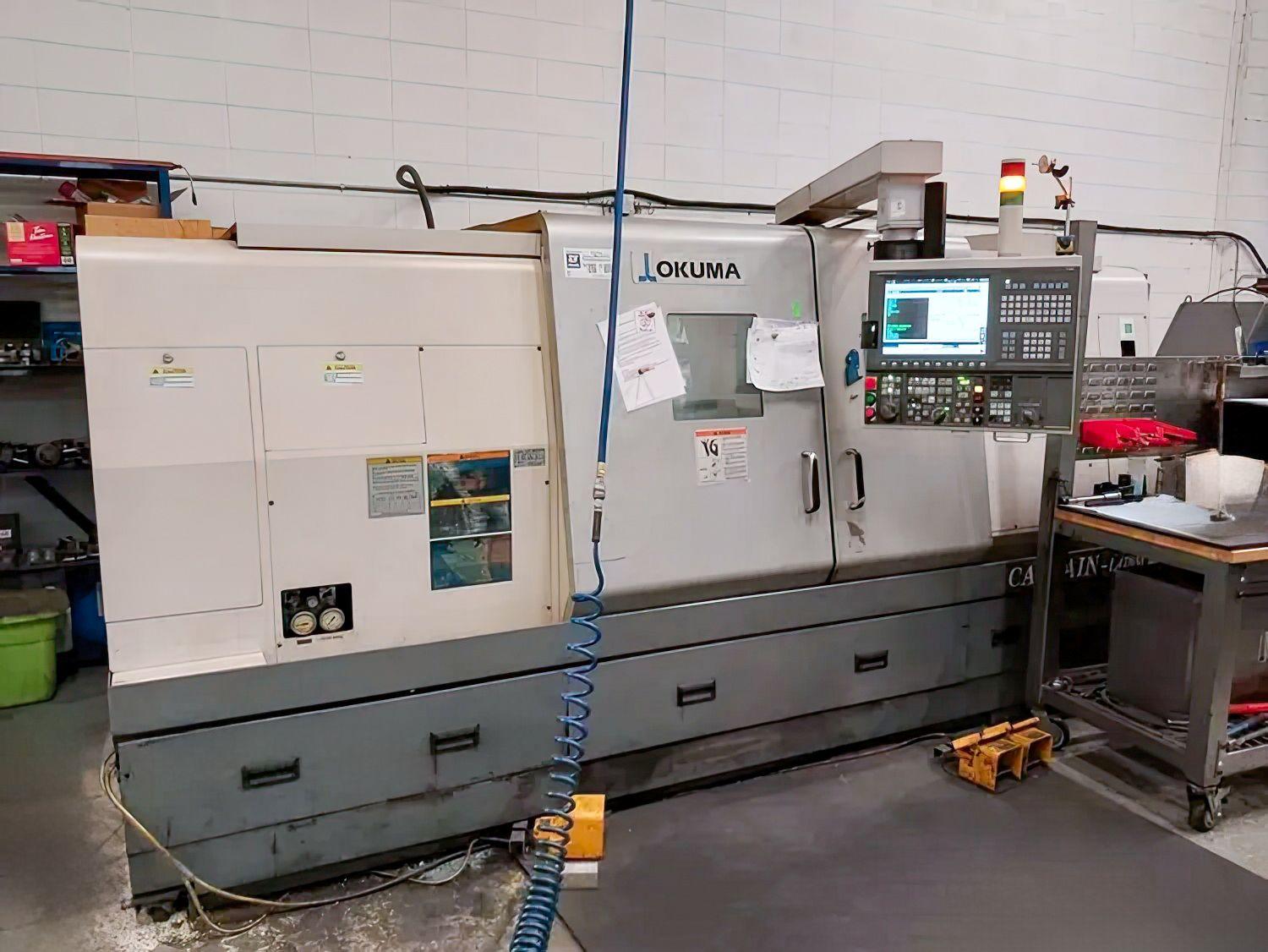 OKUMA L470M #MDWmxaScbMWDTkpsUh7MjgqLk